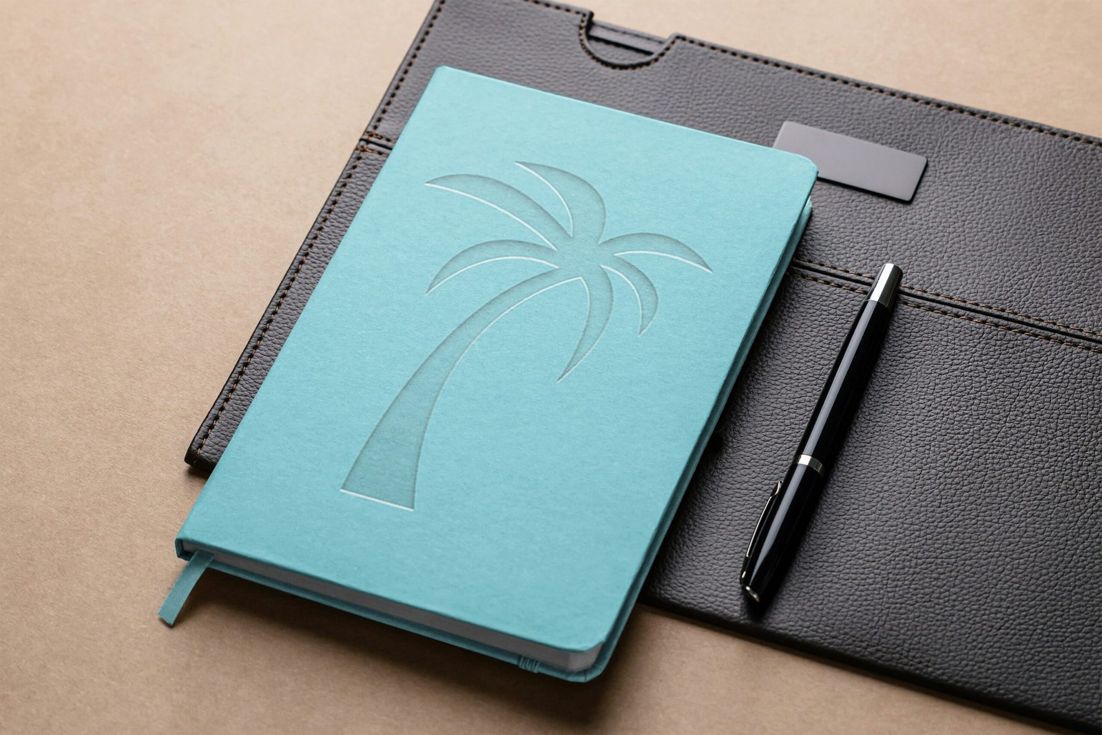 a notebook with a pen on top of it